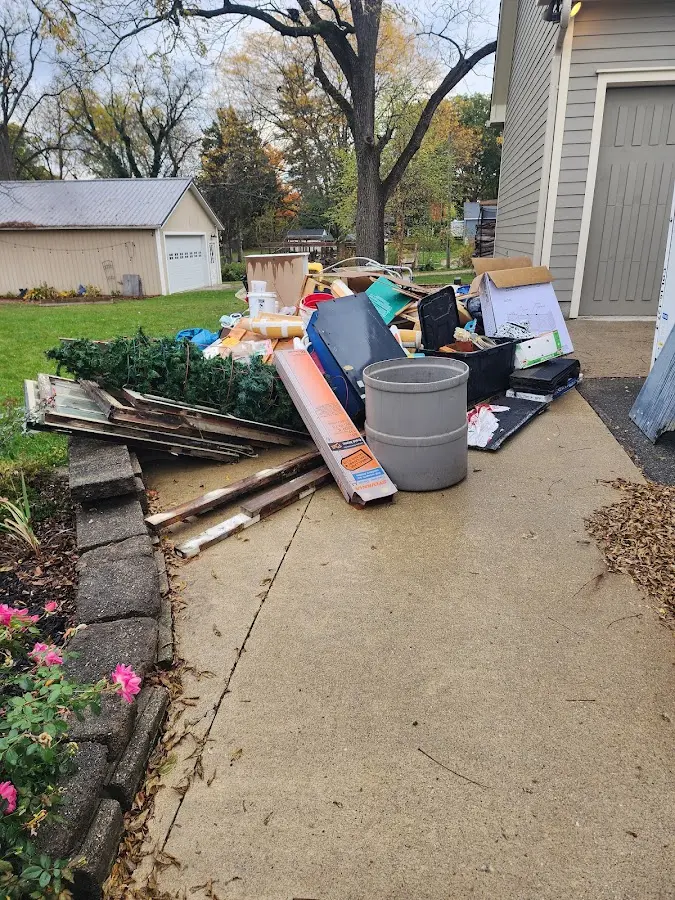 Dumpster being loaded with debris for Estate Cleanout Dumpster Rental in Farr West